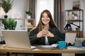 Confident young woman writing message during mobile conversation at office. Royalty Free Stock Photo