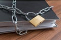 Confidential files and documents in binder locked with padlock and chain. Privacy and security concept. Royalty Free Stock Photo