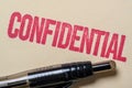 Confidential stamp on a manilla folder with a pen Royalty Free Stock Photo