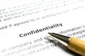 Confidentiality agreement with wooden pen Royalty Free Stock Photo