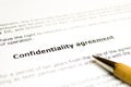 Confidentiality agreement with wooden pen Royalty Free Stock Photo
