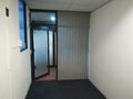 Confined office space with the open door leading out