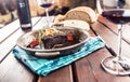 Confit beef steak with sauce fried onion bread red wine and deco Royalty Free Stock Photo