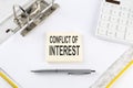 CONFLICT OF INTEREST - business concept, message on the sticker on folder background with calculator