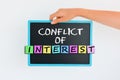 Conflict of interest concept on blackboard