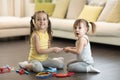 Conflict between little sisters. Kids are fighting, toddler girl takes toy, sibling relationships