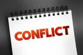 Conflict - struggle and a clash of interest, opinion, or even principles, text on notepad concept background Royalty Free Stock Photo