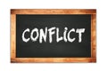 CONFLICT text written on wooden frame school blackboard