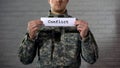 Conflict word written on sign in hands of soldier, military annexation, war