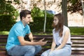 Conflicted couple not talking to each other seated on a wooden bench in park Royalty Free Stock Photo