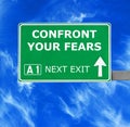 CONFRONT YOUR FEARS road sign against clear blue sky