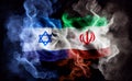 The confrontation between Israel and Iran. Israel and Iran flags in smoke shape on black background. Concept of conflict war. Royalty Free Stock Photo