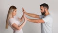 Confronting home repressor. Man presses woman with his hands, girl resists Royalty Free Stock Photo