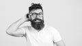 Confused bearded young man in glasses. Hipster trying to solve difficult problem. Bearded guy tries to gather with thoughts. Royalty Free Stock Photo