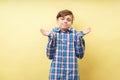 Confused bewildered boy lifting hands rising hands Royalty Free Stock Photo