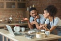 Confused black couple cooking pastry with recipe on laptop