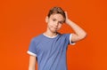 Confused boy scratching his head with puzzled expression Royalty Free Stock Photo