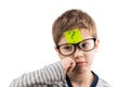 Confused boy thinking with question mark on sticky note on forehead Royalty Free Stock Photo