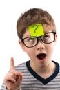 Confused boy thinking with question mark on sticky note on forehead Royalty Free Stock Photo