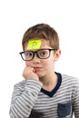 Confused boy thinking with question mark on sticky note on forehead Royalty Free Stock Photo
