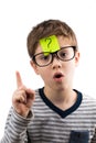 Confused boy thinking with question mark on sticky note on forehead Royalty Free Stock Photo