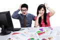 Confused business team analyzing business chart Royalty Free Stock Photo