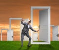 Confused businessman in front of doors Royalty Free Stock Photo