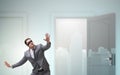 Confused businessman in front of doors Royalty Free Stock Photo