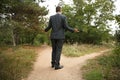 Confused businessman standing at crossroads. Concept of choice