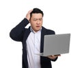 Confused businessman in suit with laptop on white background Royalty Free Stock Photo