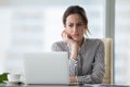 Confused businesswoman annoyed by online problem looking at laptop Royalty Free Stock Photo