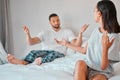 Confused, conflict and fight of couple in bedroom with doubt, liar and trust problem in marriage. Frustrated Royalty Free Stock Photo