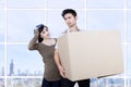 Confused couple bring box at apartment