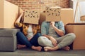 Confused couple of having to move and arrange all the packages. Concept of success, delusion, change , future, confusion