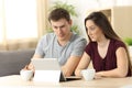 Confused couple receiving on line news Royalty Free Stock Photo