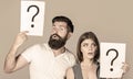 Confused couples with question marks. Conflict between two people. Pensive man and a thoughtful woman, conflict Royalty Free Stock Photo