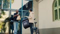 Confused delivery worker giving wrong fastfood order to customer