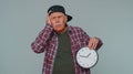 Confused senior man with anxiety checking time on clock running late to work being in delay deadline Royalty Free Stock Photo