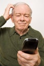 Confused elderly man with remote control Royalty Free Stock Photo