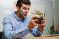 Confused frustrated male manager looking at mobile phone