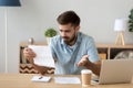 Confused frustrated man holding mail letter reading shocking unexpected news