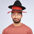 Confused, hats and young man in a studio with a thinking, idea or contemplating face expression. Pensive, thoughtful and Royalty Free Stock Photo