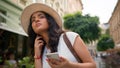 Confused Indian Arabian woman travel alone lost female tourist traveler girl on street sightseeing use mobile phone gps Royalty Free Stock Photo