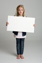 Confused little girl holding sign Royalty Free Stock Photo