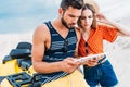 confused lost young couple with ATV using digital tablet