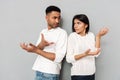 Confused loving couple gesturing with hands Royalty Free Stock Photo