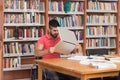 Confused Male Student Reading Many Books For Exam Royalty Free Stock Photo