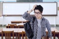 Confused male student standing in class Royalty Free Stock Photo