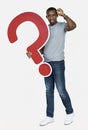 Confused man holding a question mark icon Royalty Free Stock Photo