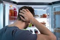 Young Man Searching For Food In Refrigerator Royalty Free Stock Photo